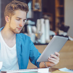 Jeune homme avec une tablette numérique.